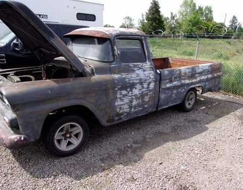 Rusty vintage pickup truck with open hood