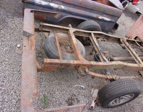 Rusty pickup truck frame with wheels