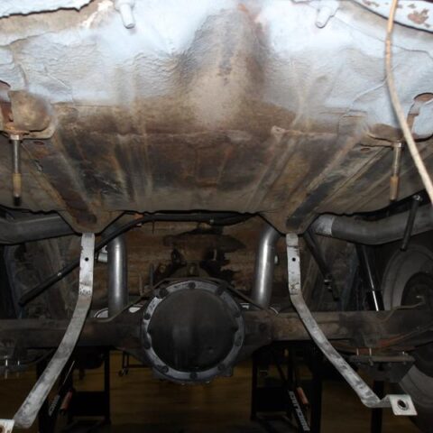 Underside view of a vehicle's rear axle and suspension system.