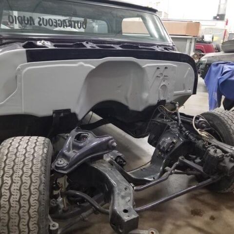 Disassembled classic car front chassis in workshop