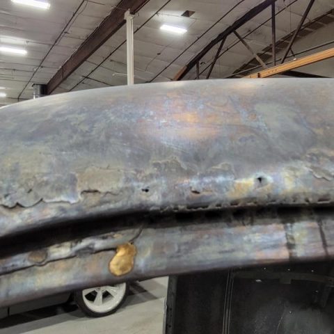 Close-up of welded, rusted car roof seam