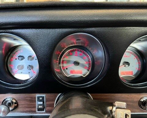 Close-up of a classic car's speedometer and gauges.