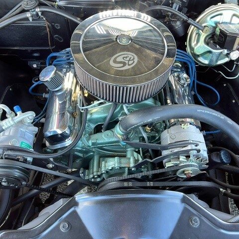 Close-up of a clean, polished car engine with an air filter.