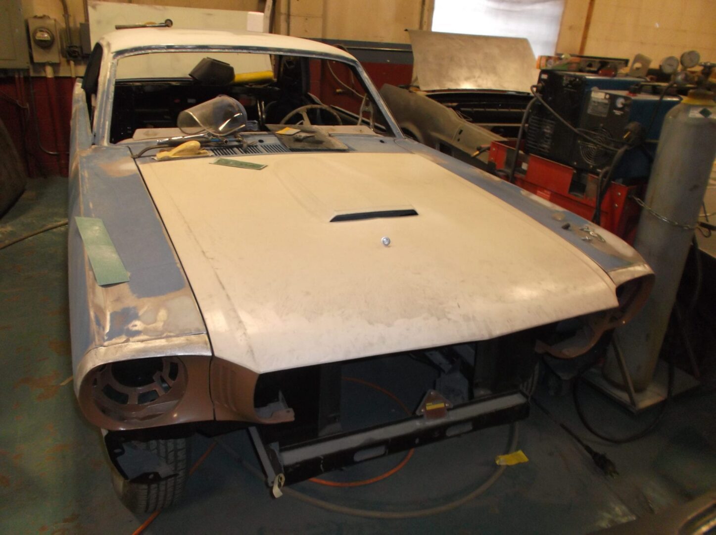 Classic car undergoing restoration in garage