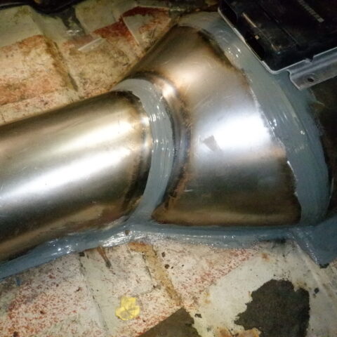 Close-up of a metal pipe joint with weld seams.
