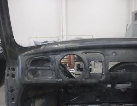 Stripped vintage car dashboard metal shell