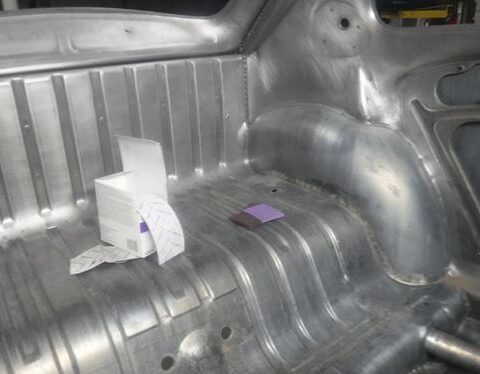 Bare metal car trunk interior with small box