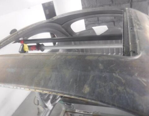 Car roof panel under repair with clamps