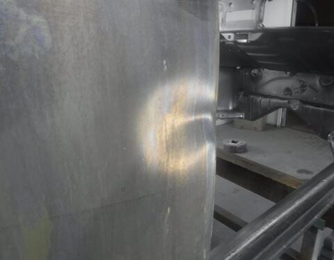 Light reflection on metal tank near chassis