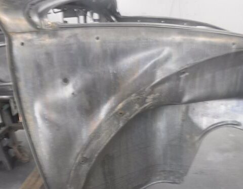 Unpainted metal car fender panel