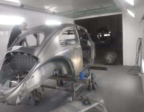 Vintage car body being restored in workshop