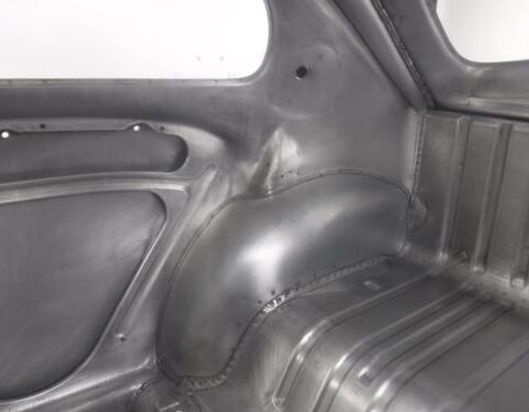 Bare metal car interior showing wheel well
