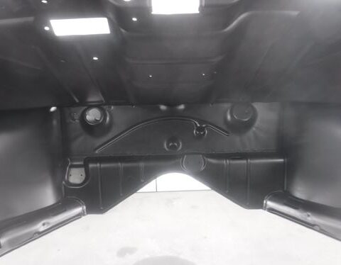 Empty black car trunk interior with wheel wells