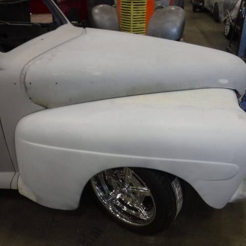 Classic car primed fender with chrome wheel