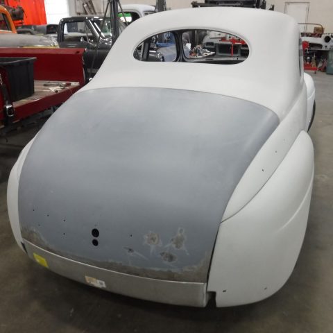 Classic car body undergoing restoration in workshop