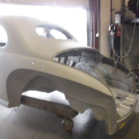 Classic car body shell in garage workshop