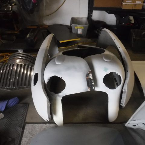 White vintage car front cowl in workshop