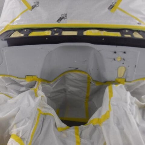 Masked car trunk opening prepped for painting