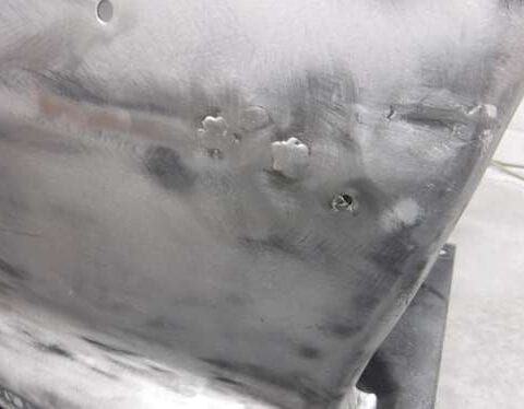 Sanded auto body panel with weld spots