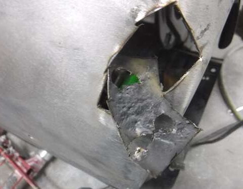 Damaged sheet metal with welded repair patch