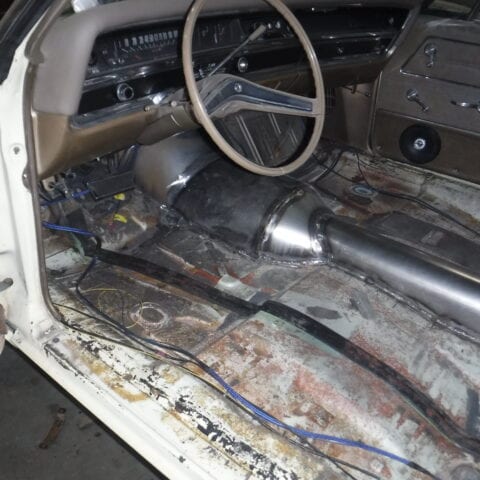 Vintage car interior with exposed metal floor