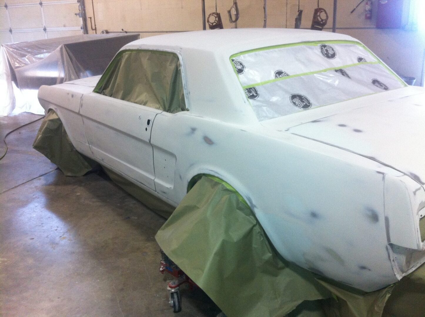 Vintage coupe primed and masked in workshop