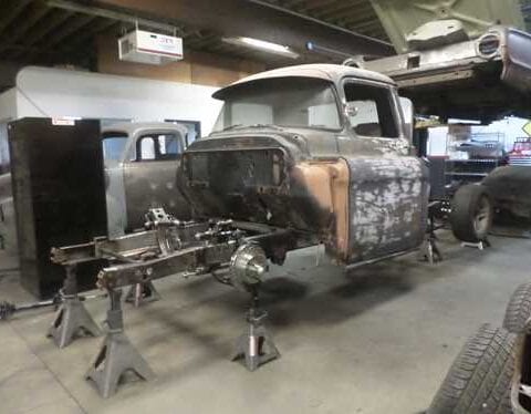 Vintage pickup truck restoration on jack stands